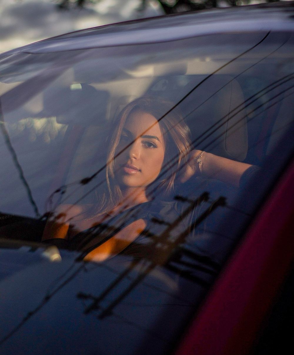 Woman looking through car window representing the transition from adult sex chat to real-life meets